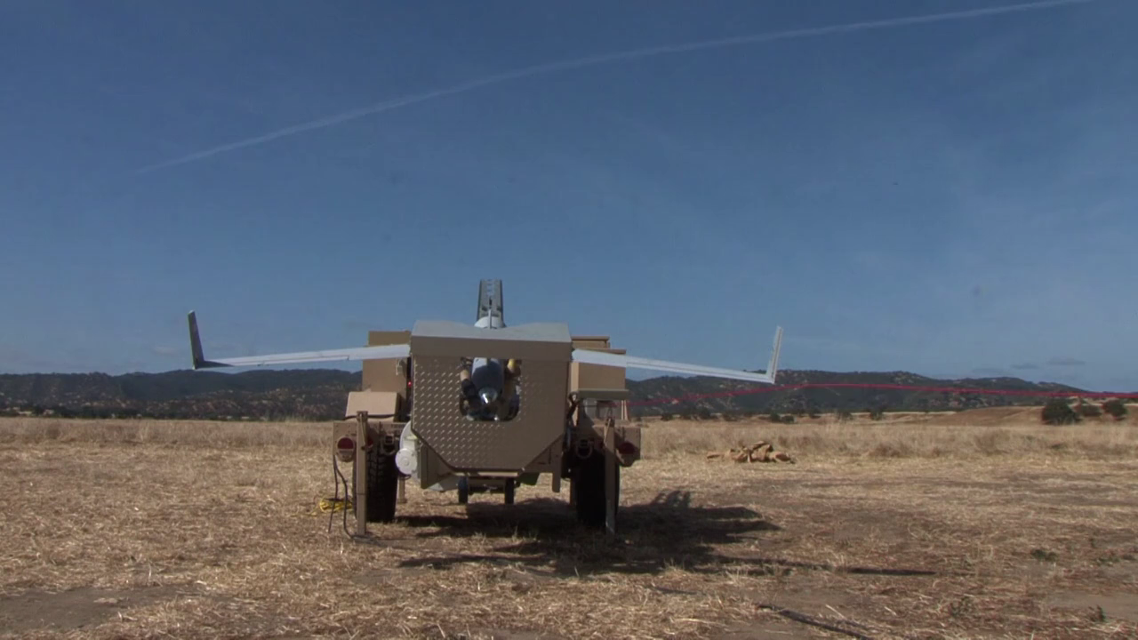 Archive rear view of a ScanEagle on its trailer-mounted rail launcher at Camp Roberts in 2015.